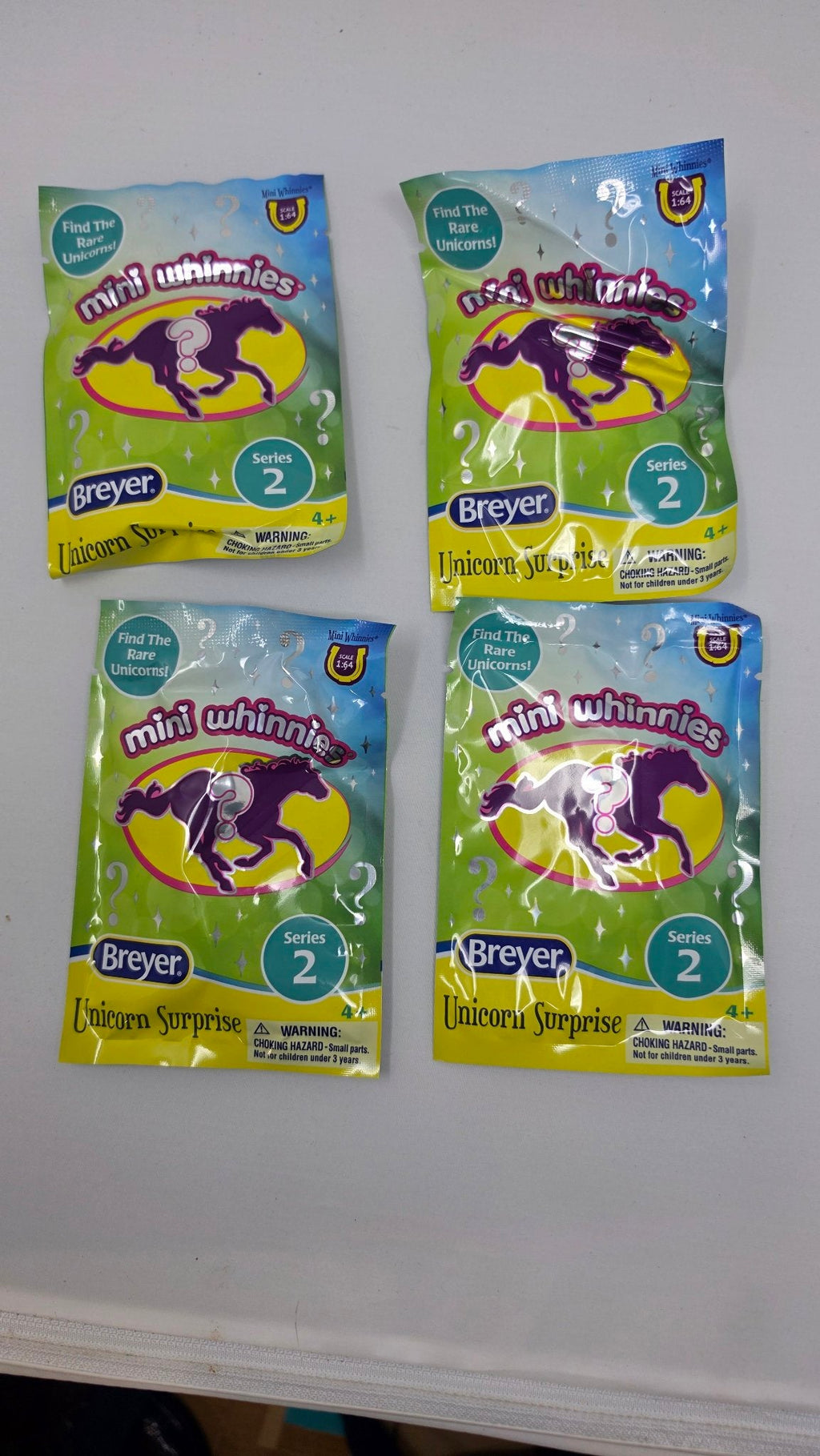 Breyer Mini Whinnies Unicorn Surprise Series 2 blind bags, front - set of 4