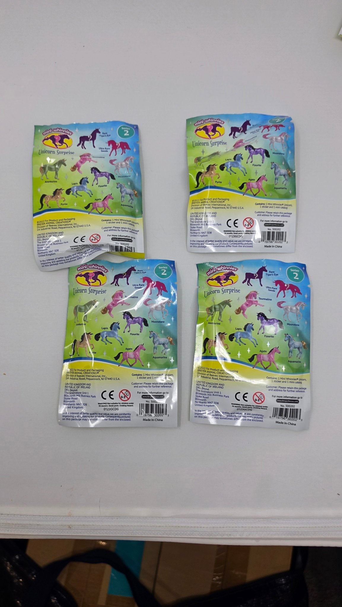 Breyer Mini Whinnies Unicorn Surprise Series 2 blind bags, back showing all 10 unicorns